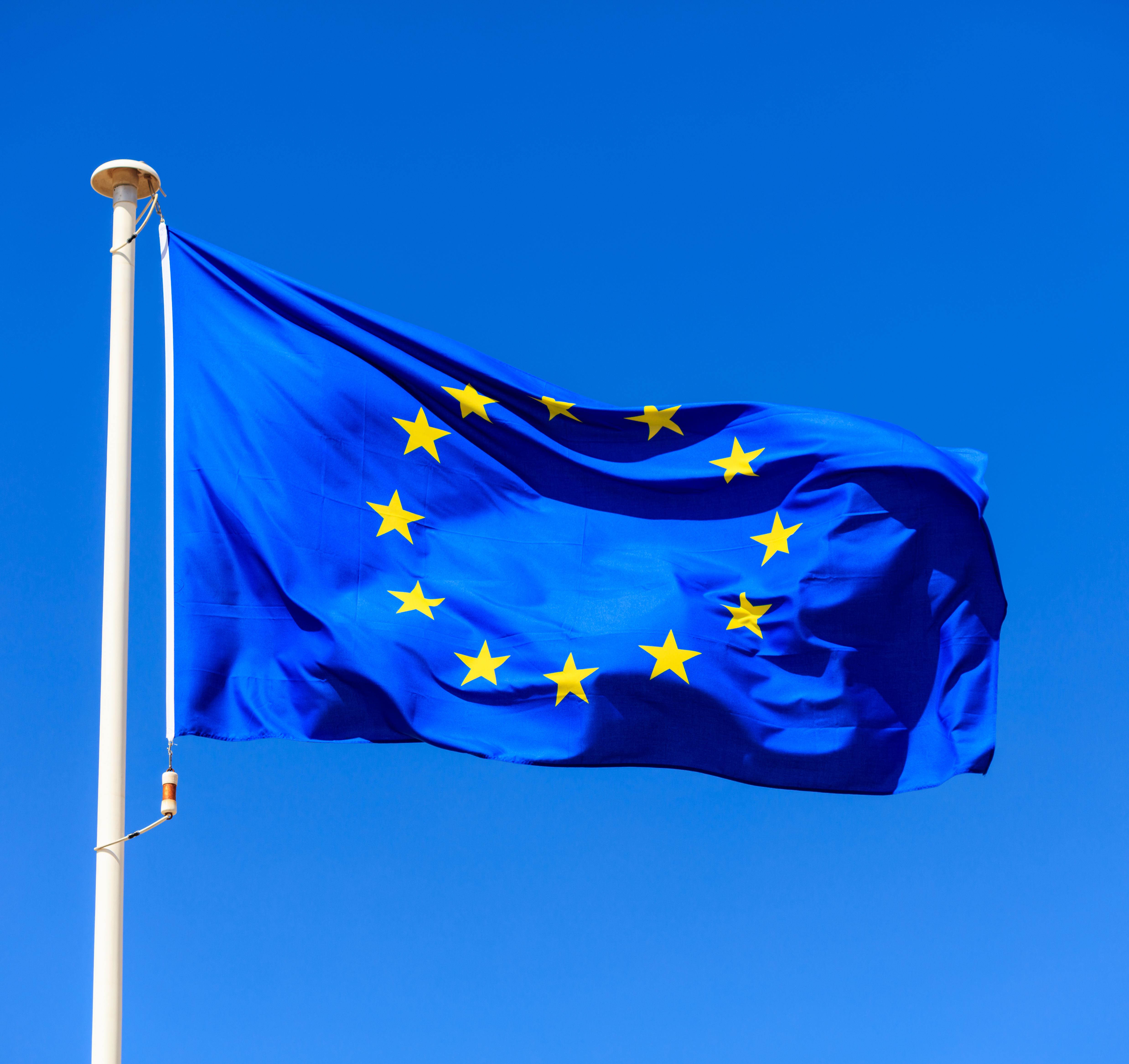 eu flag european union flag on a pole waving on bl P5QSR3A e1631186412411